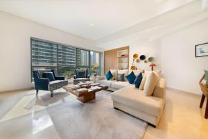 a living room with two couches and a table at Maison Privee - Stunning 3-Floor Villa with Kids Room & Rooftop Terrace over Dubai Marina in Dubai