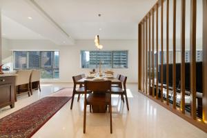 a dining room with a table and chairs at Maison Privee - Stunning 3-Floor Villa with Kids Room & Rooftop Terrace over Dubai Marina in Dubai