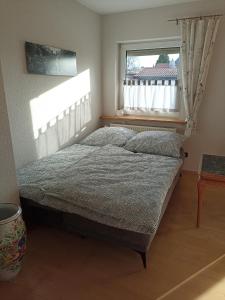 a bedroom with a bed and a window at Zimmer Frei 1 in Wiesbaden