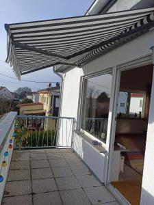 awning over a porch of a house at Zimmer Frei 1 in Wiesbaden