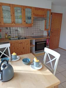 eine Küche mit zwei Tassen und Schüsseln auf dem Tisch in der Unterkunft Zimmer Frei 1 in Wiesbaden