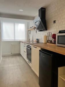 a kitchen with a sink and a stove top oven at Talako-Etxea in Bermeo