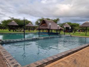 a swimming pool in a park with at Bradbury Game Lodge and Function Venue in Polokwane
