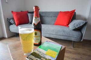 a bottle of beer sitting on a table with a glass at BLACKFOXREST Ferienwohnung in Feldberg