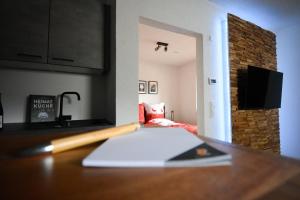 a desk with a book and a pen on a table at BLACKFOXREST Ferienwohnung in Feldberg