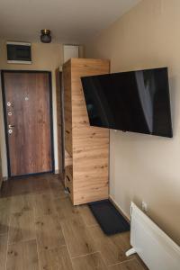 a large flat screen tv hanging on a wall at Apartman Ambijent Divcibare in Divčibare