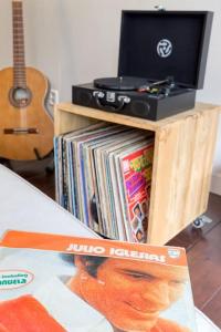 a magazine sitting on a table next to a music cabinet at Rotterdam's coolest apartment in Rotterdam