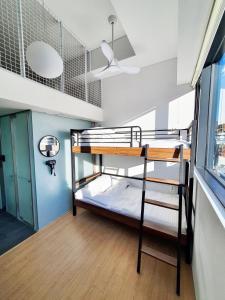 um beliche num quarto com uma janela em YOLO Guesthouse em Seul