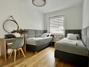 Posteľ alebo postele v izbe v ubytovaní Apartament Cobena