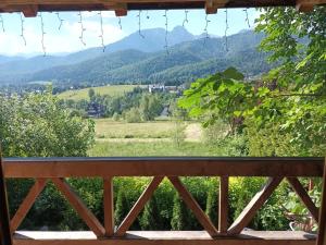 a view of the mountains from the porch of a house at Szałas u Szpunara in Kościelisko