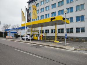 a hotel with a yellow and white building at HOTEL JURKI DOM in Bratislava