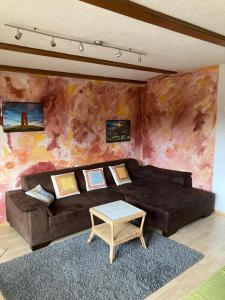 a living room with a couch and a table at Ferienhaus Wieswald in Ehrwald