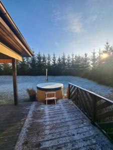 a wooden deck with a bath tub and a bench at Włókna Inn Classic in Potrzanowo +36 photos