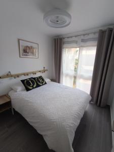 een slaapkamer met een groot wit bed en een raam bij JR apartment albir in Albir