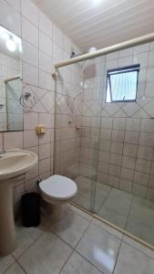 y baño con ducha, aseo y lavamanos. en Otimo apartamento em Balneário Camboriu, en Balneário Camboriú