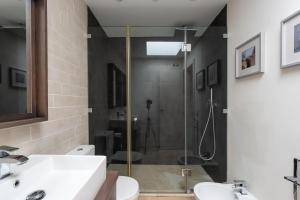 a bathroom with a shower and a sink and a toilet at Chalet Cortijo Blanco I in Marbella