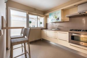 a kitchen with a chair and a stove top oven at Chalet Cortijo Blanco I in Marbella