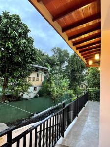 a balcony with a view of a fence and trees at SOHA Residency in Gampaha