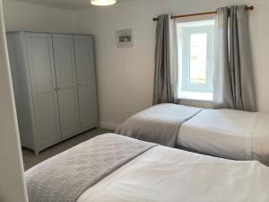 a bedroom with two beds and a window at The Granary in Bridlington