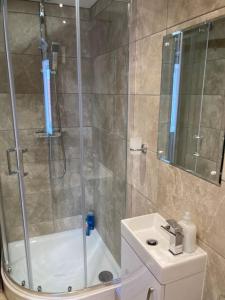 a bathroom with a shower and a toilet and a sink at The Granary in Bridlington