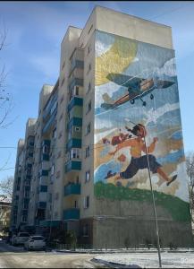 a building with a mural on the side of it at Zhalgin's apartments 2 in Turksib