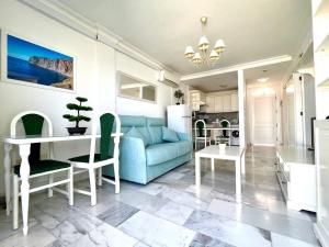 a living room with a blue couch and a table at Buenavista Top Floor Penthouse in Santiago del Teide