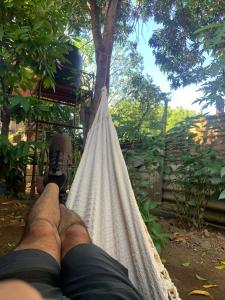 a person laying in a hammock with their feet up at Hostel Casa María in Masaya
