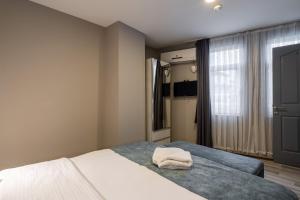 a bedroom with a bed with two towels on it at Element Residence in Istanbul