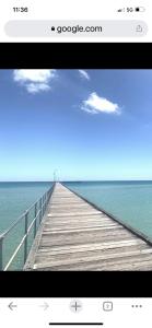 a television screen showing a pier over the water at OCEAN GET AWAY in Rye