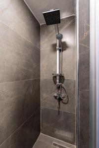 a shower stall with a shower head in a bathroom at Element Residence in Istanbul