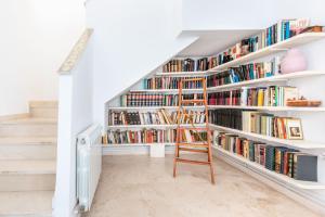 a staircase with bookshelves filled with books at Apartamento Dúplex Los Cartujanos I in Marbella