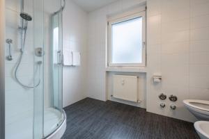 a bathroom with a shower and a sink and a toilet at Avia Living in Brunico +10 photos