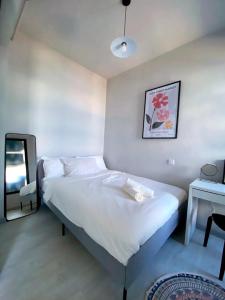 a small bedroom with a bed and a mirror at Jesselton Quay by Bunga Raya Homes in Kota Kinabalu
