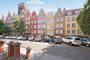a row of cars parked in a parking lot in front of buildings at Hello Apartments Sw Ducha Loft for 4 guests in Gdańsk