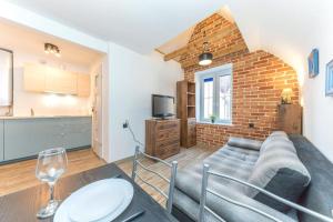 a living room with a couch and a table at Hello Apartments Sw Ducha Loft for 4 guests in Gdańsk