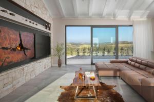 a living room with a couch and a table at Villa Royale Croatia with Golf Green in Brtonigla in Brtonigla