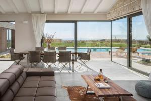 a living room with a couch and a table at Villa Royale Croatia with Golf Green in Brtonigla in Brtonigla