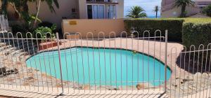 a swimming pool with a fence around it at 4 Main Sail Port St Francis in St Francis Bay