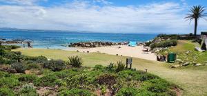a beach with people on the sand and the ocean at 4 Main Sail Port St Francis in St Francis Bay