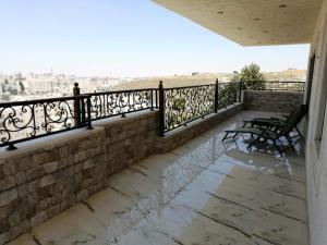 a balcony with benches and a view of the city at Beautifull Rooftop with an Amazing Terrace View in Amman