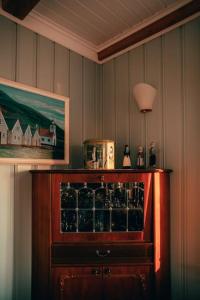 a room with a cabinet with a wine glass at Tanginn in Stykkishólmur