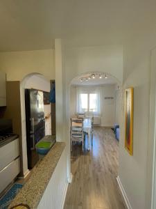 a kitchen and living room with a table and a dining room at La casa di Camilla in Cannigione +12 photos