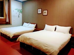 Postel nebo postele na pokoji v ubytování Ju Jia Xiao Zhan Homestay