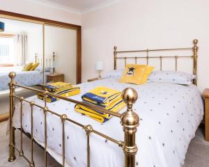 a bedroom with a white bed with a metal frame at No27 Willowbank in Dunkeld