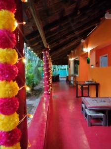 a room with a red carpet and flowers on the wall at Paradise Vana Vilasa Homestay with Swimming pool in Auroville +102 photos