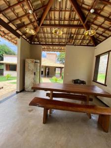 a group of wooden benches sitting in a room at Casa Jatobá da Serra in Serra do Cipo