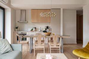 a kitchen and living room with a table and chairs at W Apartments Kalaranna I in Tallinn