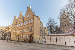 a large building on the side of a street at Hello Apartments Sw Ducha Loft for 6 guests in Gdańsk