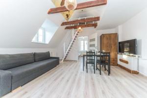a living room with a couch and a table at Hello Apartments Sw Ducha Loft for 6 guests in Gdańsk