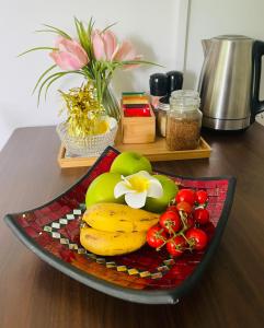 a plate of fruit and vegetables on a table at Eumundi Cottage in Town in Eumundi